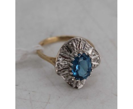 A modern 9ct gold, blue zircon and diamond point set dress ring, 2.9g, size K