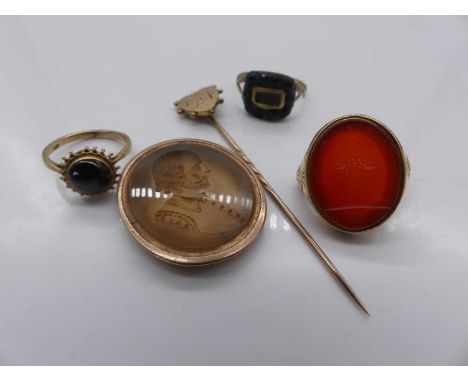 An early 19th century 18ct gold part signet ring, having a carnelian set seal, together with a yellow metal and carved hardst