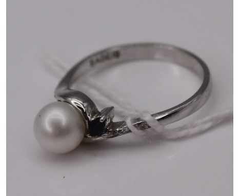 A contemporary white metal, cultured pearl, sapphire and diamond point set dress ring, stamped 585, 2.9g, size O