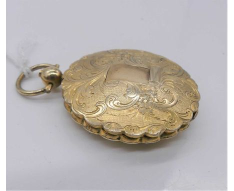 A Victorian gold plated and engraved circular  pendant locket, the dia. 36mm