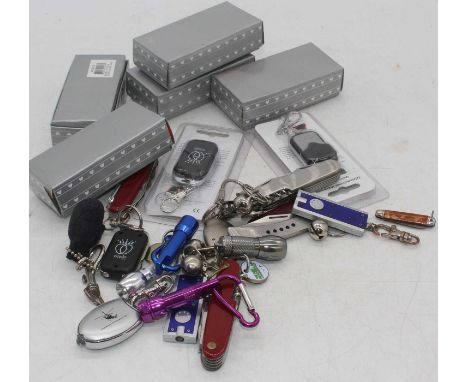 A collection of vintage key-chains and pocket knives