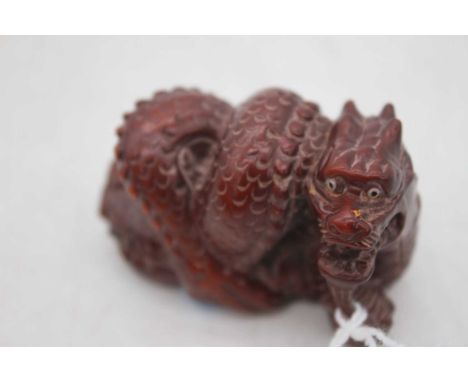 A reproduction carved netsuke in the form of a dragon, 5cm