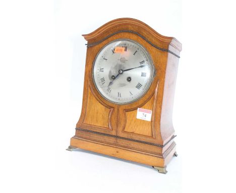 An early 20th century oak cased eight-day mantel clock, the silvered dial showing Roman numerals and signed Dent London, h.31