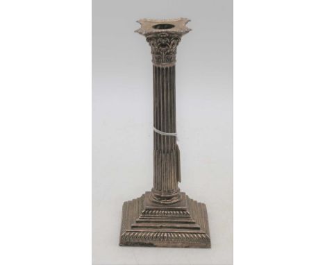 A silver table candlestick in the form of a Corinthian column, marks rubbed, h.22cm (loaded)