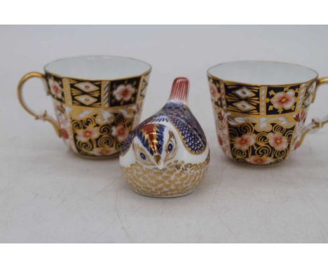 A pair of Royal Crown Derby imari coffee cans, pattern No.2451; together with a Royal Crown Derby model of a bird (3)