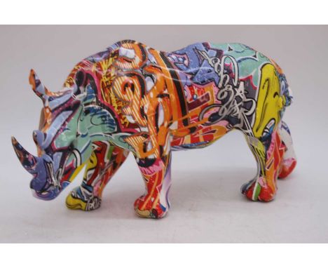 A modern resin polychrome decorated model of a rhinoceros, h.17cm