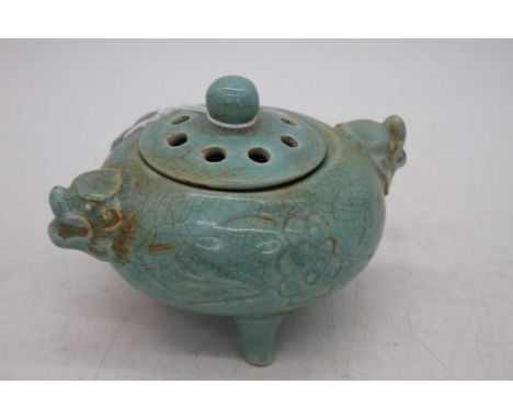 A Chinese blue glazed tripod censor, flanked by twin mask handles, w.14cm 