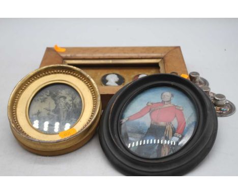Three cameo portrait busts, housed within a birds-eye maple frame; together with two oval framed prints 