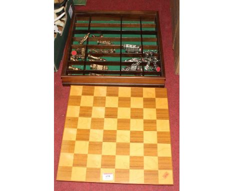 A vintage cast metal chess set and board 