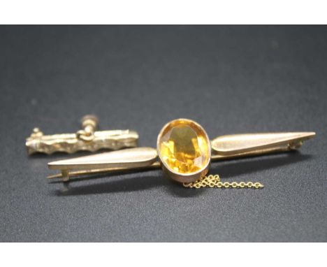 A 9ct gold and citrine set bar brooch, the oval cut citrine measuring approx 15 x 11mm, 5.5g, 65mm; together with a gilt meta