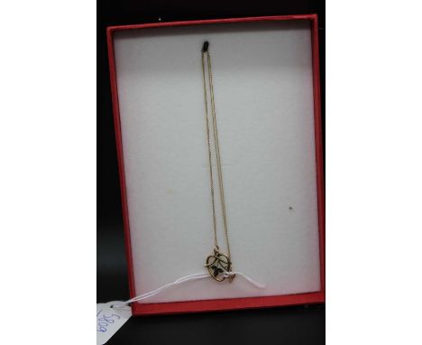 An Edwardian 9ct gold and enamel openwork pendant on finelink neck chain, pendant height 15mm