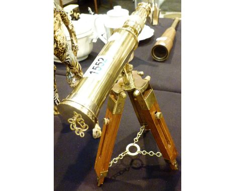 BRASS TELESCOPE. Polished brass telescope on wooden tripod base, H: 30 cm