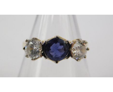 A 9ct gold blue and clear cubic zirconia three stone ring, size K, 2.8g.
