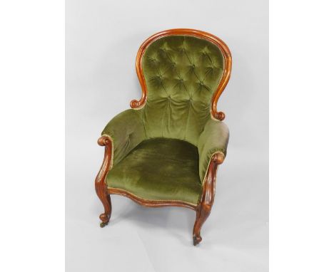 A Victorian mahogany balloon back armchair, with green button back upholstery and overstuffed serpentine seat, raised on cabr