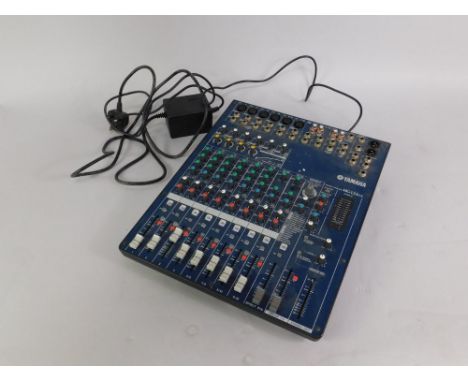 A Yamaha MG124CX mixing console, with power supply.