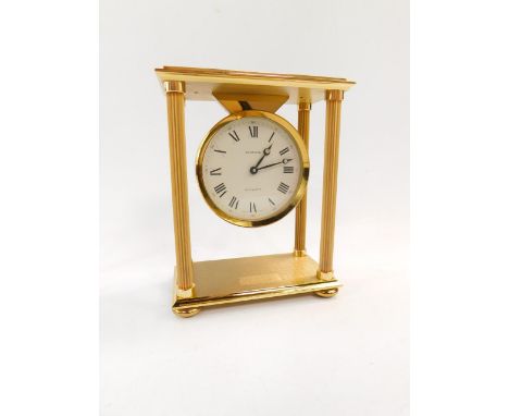 A Garrard brass quartz mantel clock, of portico form, raised on four bun feet, No 1828397, circular dial bearing Roman numera