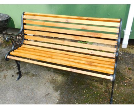 A wooden bench with black iron ends, 123cm x 56cm x 72cm.