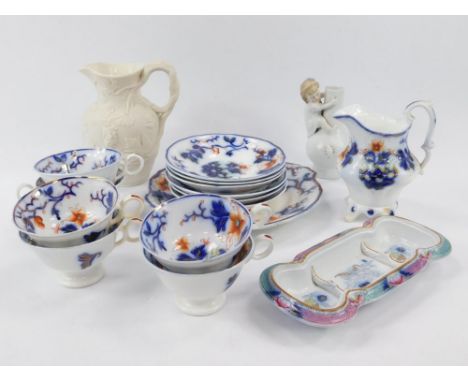 An early 19thC porcelain part tea service, imari decorated with flowers, comprising  cream jug, bread plate, six tea cups and