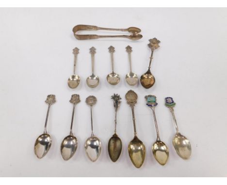 A pair of Victorian silver sugar tongs, London 1863, five spoons with terminals for the Calcutta Scottish Regiment, and seven