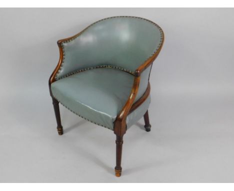 A Victorian mahogany tub armchair, upholstered  in button backed grey leatherette fabric with an overstuffed seat, raised on 