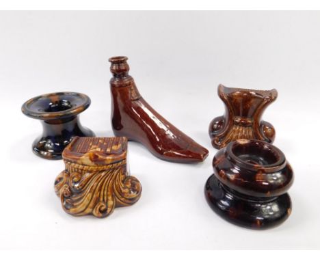 Two 19thC brown glazed sash window rests, of scrolling leaf form, a brown treacle glazed bottle modelled as a shoe, and two s