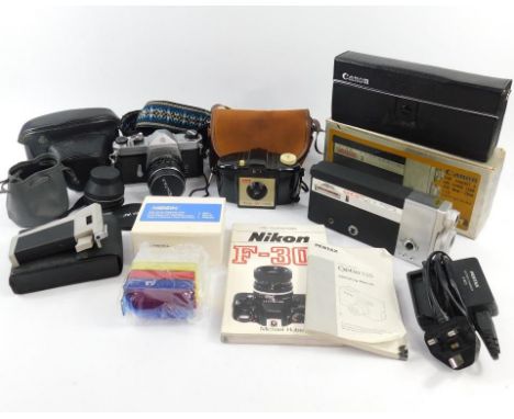 An Asahi Pentax Spotmatic camera, with a Super-Takuma 1:1,4-50 lens, accessories, a Kodak Brownie 127 camera, and a Canon Cin