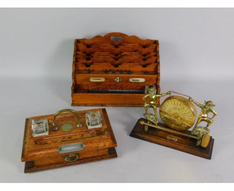 A Victorian oak stationery rack, with perpetual calendar, pen tray and inkwell, of waterfall rectangular form, 37cm x 21cm x 