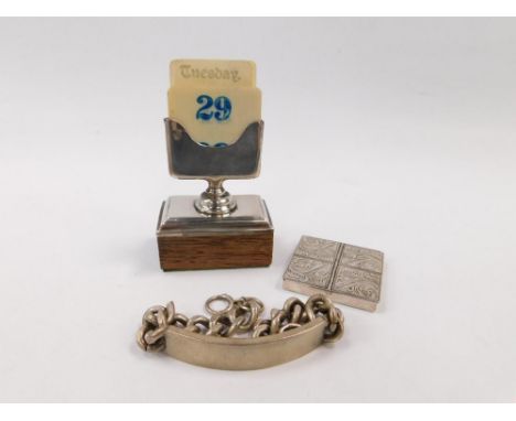 A George V silver and ivory perpetual desk calendar, raised on an oak base, Birmingham 1925, together with a silver four sect