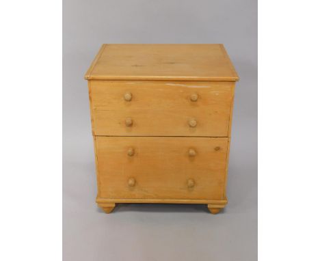 A Victorian pine commode, with dummy drawer frontage, opening to reveal the seat with pot and lid, raised on turned feet, 60.