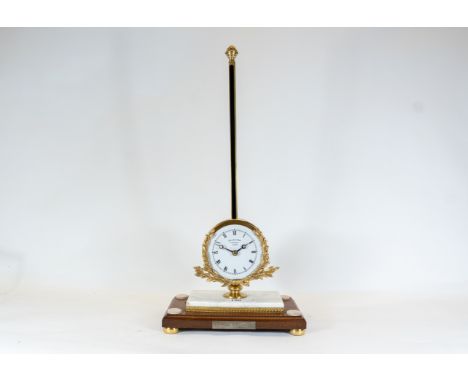 Thwaites &amp; Reed, London, a reproduction limited edition gravity clock with white enamel dial, and floral cast bezel ornam