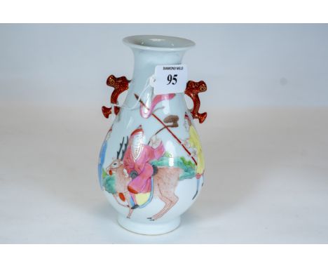 A Chinese porcelain pear shaped vase, twin side handles, polychrome decorated with a figure riding a stag, two attendants &am