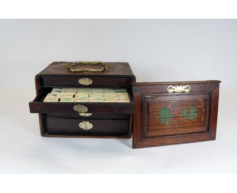 An Anlique Chinese hardwood cased Mahjong set, bone &amp; bamboo playing pieces, the box with metal mounts &amp; carry handle