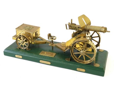 A Large Brass Model of a First World War Vickers Machine Gun, Carriage and Limber, the green painted wood rectangular plinth 