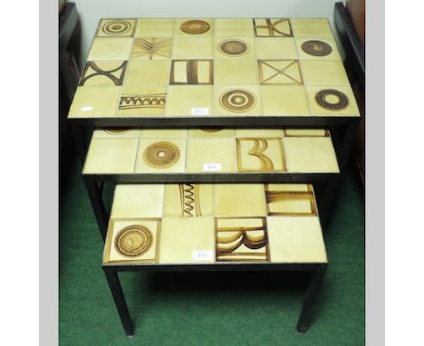A nest of three 1970's tile top tables, 67cm