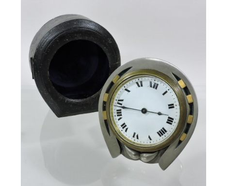 An early 20th century steel cased drum clock, in the form of a horseshoe, inset with seven brass lucky nails, the white ename
