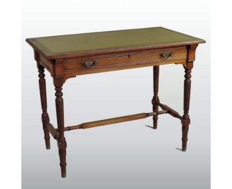 A 19th century light oak writing table, by Gillows, with a gold leather inset top, above a single frieze drawer, on turned le