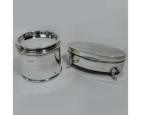 An early 20th century silver trinket box, of hinged oval shape, on paw feet, Birmingham 1919, with presentation inscription, 