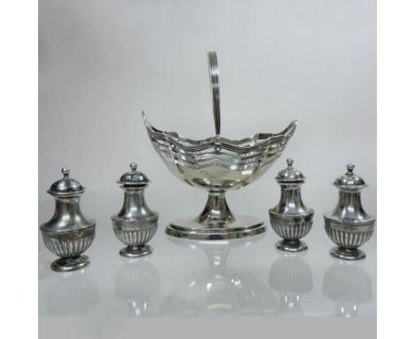 An Edwardian silver pedestal sugar basket, of pierced boat shape, with a swing handle, Chester 1900, 13cm, together with a se