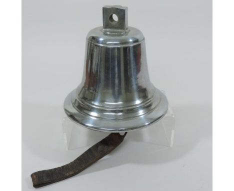 A Second World War silvered cast bronze fire engine bell, with a cast iron clapper and leather strap, 20cm tall