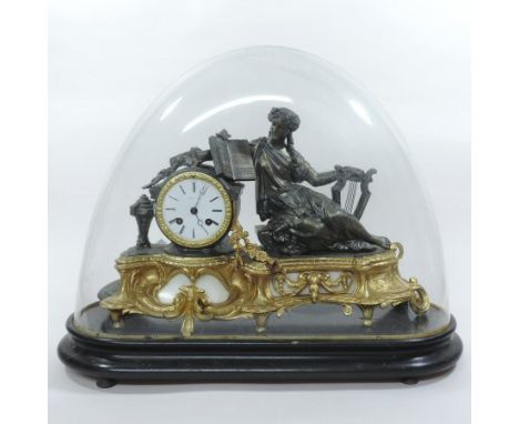 A French gilt metal and bronzed figural mantle clock, with a white enamel dial, surmounted by Orpheus reclining, having a twi