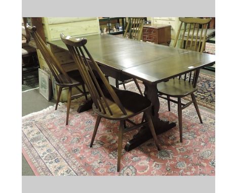 An Ercol dark elm draw leaf table, 176 x 71cm, together with four matching chairs