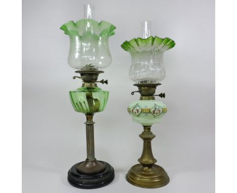 A Victorian brass oil lamp, with a green glass reservoir and frilled rippled glass shade, marked English made, 61cm tall, tog