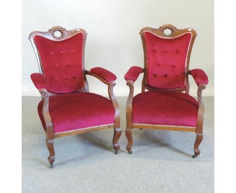 A pair of Victorian mahogany and red upholstered button back armchairs