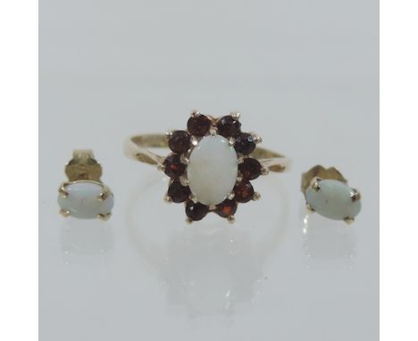 A 9 carat gold opal and garnet cluster ring, together with a pair of opal stud earrings, boxed