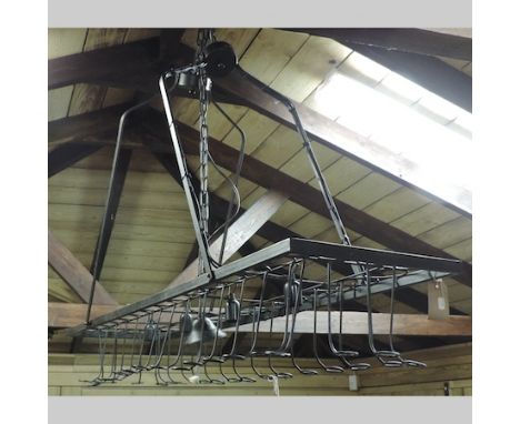 A black painted metal ceiling light wine rack, 150cm