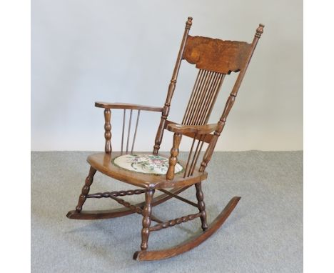 A 19th century American rocking chair, with a tapestry seat