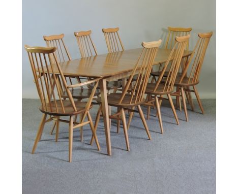 An Ercol light elm extending dining table, 220 x 83cm, together with a set of six matching dining chairs, to include two carv