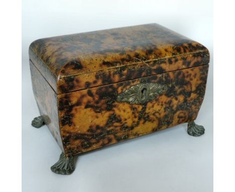 A Regency simulated tortoiseshell tea caddy, of hinged rectangular shape, and compartmented interior, with a foliate escutche
