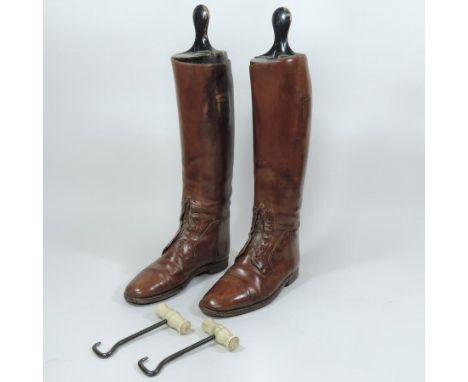 A pair of 19th century gentleman's brown leather lace up military field boots, stamped 8 E365418, 1793, with ebonised wooden 