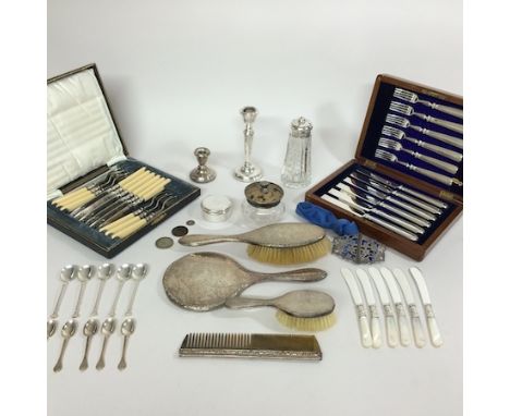 A collection of silver dressing table items, together with a candlestick, nurse's buckle, and two cutlery sets, cased